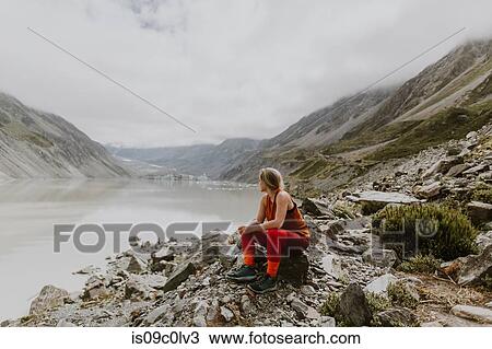 Woman enjoying scenic view by lake, Wanaka, Taranaki, New Zealand View Large Photo Image Stock Image - Woman enjoying scenic view by lake, Wanaka, Taranaki, New Zealand. Fotosearch