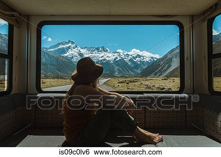 Stock Photograph - Woman enjoying view from inside motorhome, Wanaka, Taranaki, New Zealand. Fotosearch