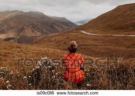 Stock Photograph - Woman enjoying view of scenic landscape, Queenstown, Canterbury, New Zealand. Fotosearch
