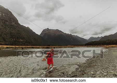Woman exploring lake, Queenstown, Canterbury, New Zealand View Large Photo Image Stock Image - Woman exploring lake, Queenstown, Canterbury, New Zealand. Fotosearch