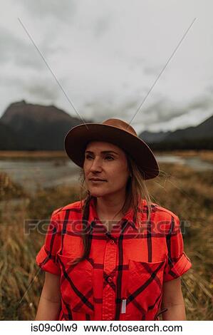 Stock Photo - Woman exploring wilderness by lake, Queenstown, Canterbury, New Zealand. Fotosearch