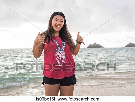 Woman giving thumbs up, Lanikai Beach, Oahu, Hawaii View Large Photo Image Stock Image - Woman giving thumbs up, Lanikai Beach, Oahu, Hawaii. Fotosearch