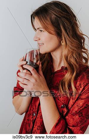 Woman holding glass of wine, white background View Large Photo Image Stock Photo - Woman holding glass of wine, white background. Fotosearch