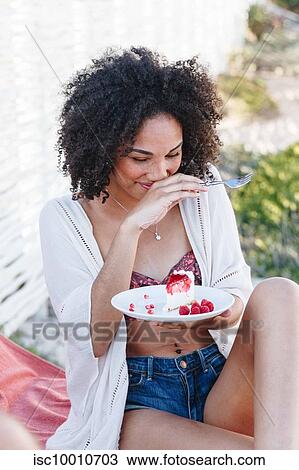 Woman holding plate of raspberry cake, covering mouth, giggling View Large Photo Image Stock Image - Woman holding plate of raspberry cake, covering mouth, giggling. Fotosearch