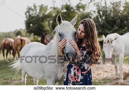 Woman hugging horse View Large Photo Image Stock Image - Woman hugging horse. Fotosearch
