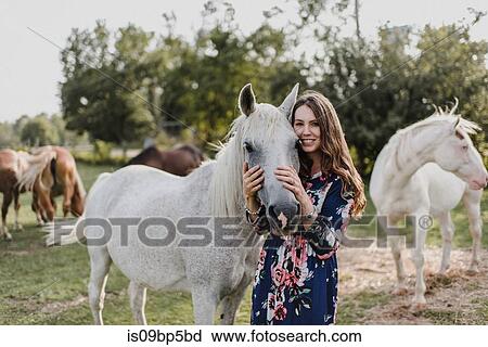 Stock Image - Woman hugging horse. Fotosearch