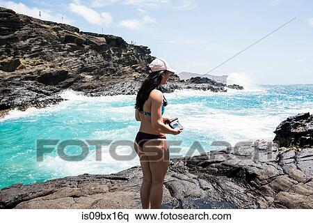 Woman in bikini on rocks, Halona Beach, Oahu, Hawaii View Large Photo Image Stock Photography - Woman in bikini on rocks, Halona Beach, Oahu, Hawaii. Fotosearch