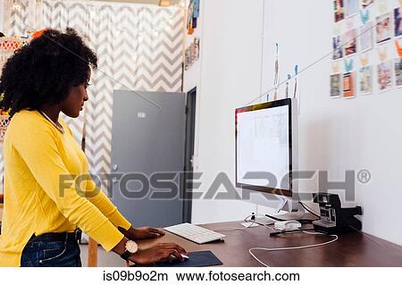 Picture - Woman in creative studio using computer. Fotosearch