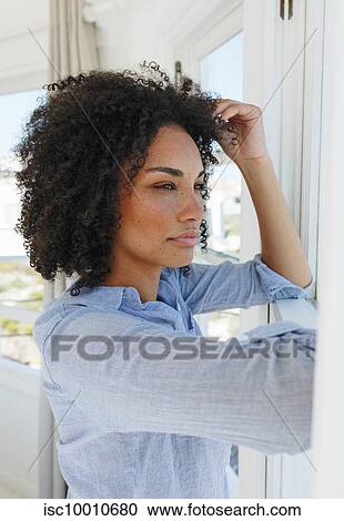 Woman in deep thought in beach house View Large Photo Image Stock Image - Woman in deep thought in beach house. Fotosearch