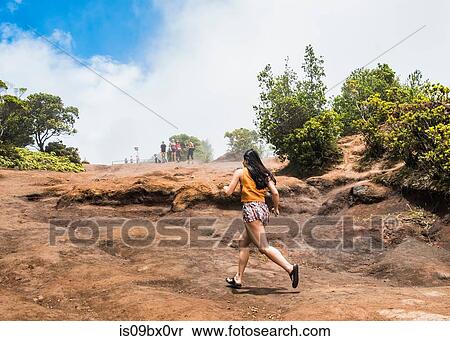 Stock Photography - Woman in hurry, Waimea Canyon, Kauai, Hawaii. Fotosearch
