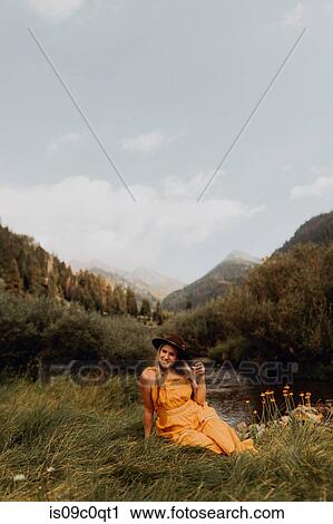 Woman in orange maxi dress sitting by rural valley river, Mineral King, California, USA View Large Photo Image Stock Image - Woman in orange maxi dress sitting by rural valley river, Mineral King, California, USA. Fotosearch