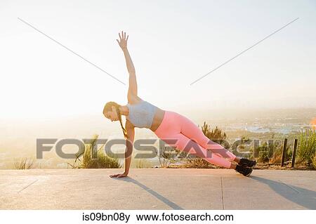 Woman in plank position on hilltop View Large Photo Image Stock Photo - Woman in plank position on hilltop. Fotosearch