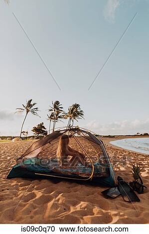 Woman in tent on sandy beach, Princeville, Hawaii, US View Large Photo Image Stock Image - Woman in tent on sandy beach, Princeville, Hawaii, US. Fotosearch