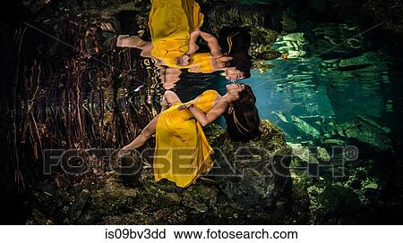 Woman in yellow gown floating underwater, Cenote, Quintana Roo, Mexico View Large Photo Image Stock Image - Woman in yellow gown floating underwater, Cenote, Quintana Roo, Mexico. Fotosearch