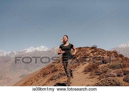 Woman jogging down from peak, Annapurna Circuit, the Himalayas, Muktinath, Nepal View Large Photo Image Stock Photo - Woman jogging down from peak, Annapurna Circuit, the Himalayas, Muktinath, Nepal. Fotosearch