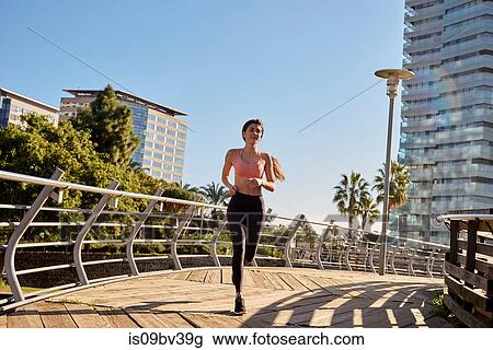 Woman jogging in city park, Barcelona, Catalonia, Spain View Large Photo Image Stock Image - Woman jogging in city park, Barcelona, Catalonia, Spain. Fotosearch