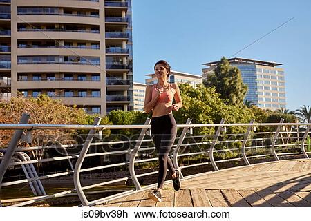 Woman jogging in city park, Barcelona, Catalonia, Spain View Large Photo Image Stock Image - Woman jogging in city park, Barcelona, Catalonia, Spain. Fotosearch
