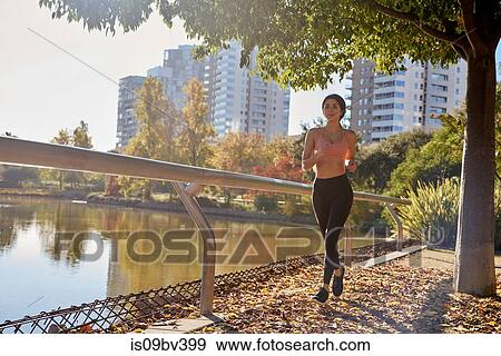Woman jogging in city park, Barcelona, Catalonia, Spain View Large Photo Image Stock Photo - Woman jogging in city park, Barcelona, Catalonia, Spain. Fotosearch