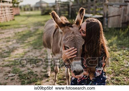 Woman kissing donkey View Large Photo Image Stock Image - Woman kissing donkey. Fotosearch