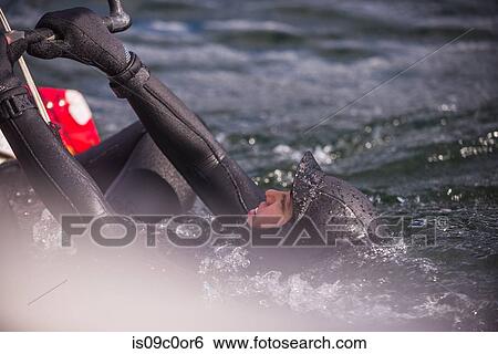Woman kite surfing in sea View Large Photo Image Stock Photograph - Woman kite surfing in sea. Fotosearch