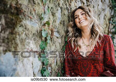 Woman leaning on old stone wall View Large Photo Image Stock Image - Woman leaning on old stone wall. Fotosearch