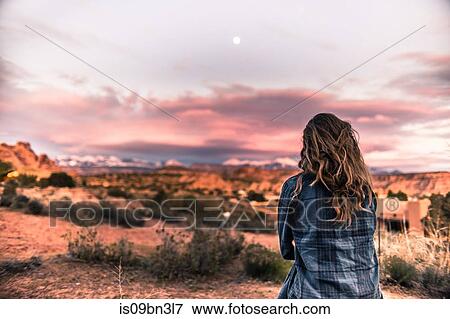 Woman looking at sunset in the desert, Moab, Utah View Large Photo Image Stock Photo - Woman looking at sunset in the desert, Moab, Utah. Fotosearch