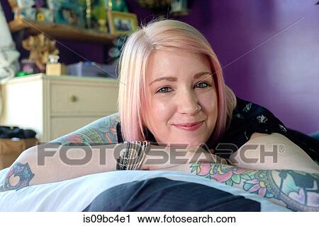 Woman lying on bed View Large Photo Image Stock Image - Woman lying on bed. Fotosearch