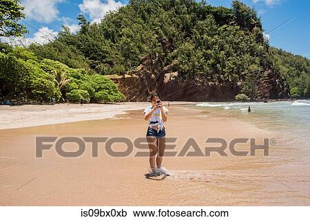 Woman on beach, Waianapanapa State Park, Maui, Hawaii View Large Photo Image Stock Image - Woman on beach, Waianapanapa State Park, Maui, Hawaii. Fotosearch