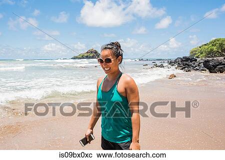 Woman on beach, Waianapanapa State Park, Maui, Hawaii View Large Photo Image Stock Image - Woman on beach, Waianapanapa State Park, Maui, Hawaii. Fotosearch