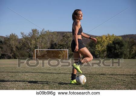 Woman on football pitch playing football View Large Photo Image Stock Image - Woman on football pitch playing football. Fotosearch