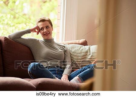Stock Photo - Woman on sofa. Fotosearch