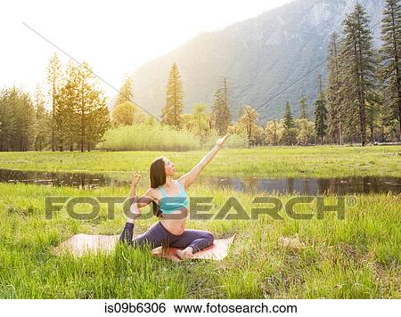 Woman practicing yoga pose by lake in Yosemite National Park, California, USA View Large Photo Image Stock Photograph - Woman practicing yoga pose by lake in Yosemite National Park, California, USA. Fotosearch