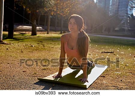 Woman practising yoga in city park, Barcelona, Catalonia, Spain View Large Photo Image Stock Image - Woman practising yoga in city park, Barcelona, Catalonia, Spain. Fotosearch