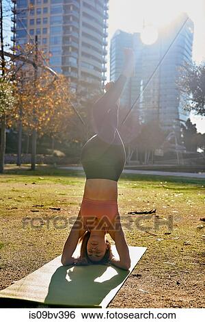Woman practising yoga in city park, Barcelona, Catalonia, Spain View Large Photo Image Stock Photograph - Woman practising yoga in city park, Barcelona, Catalonia, Spain. Fotosearch