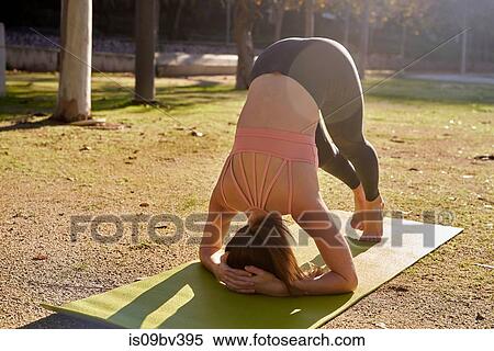 Woman practising yoga in city park View Large Photo Image Stock Photography - Woman practising yoga in city park. Fotosearch