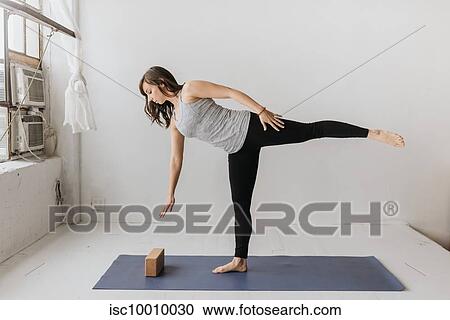 Woman practising yoga in studio View Large Photo Image Stock Image - Woman practising yoga in studio. Fotosearch