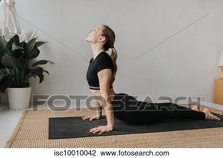 Woman practising yoga in studio View Large Photo Image Stock Image - Woman practising yoga in studio. Fotosearch
