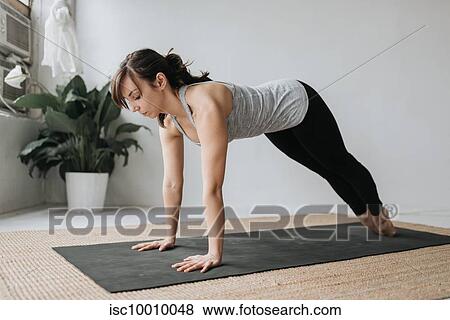 Woman practising yoga in studio View Large Photo Image Stock Photo - Woman practising yoga in studio. Fotosearch