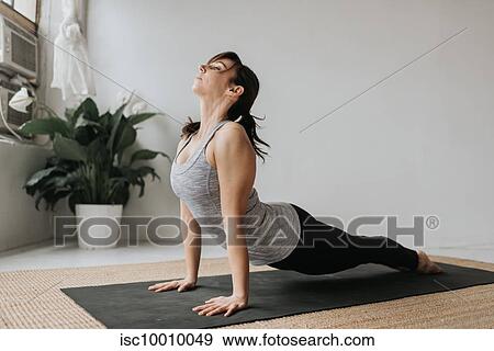 Woman practising yoga in studio View Large Photo Image Stock Photo - Woman practising yoga in studio. Fotosearch