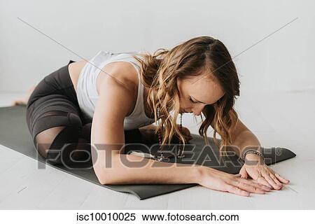 Woman practising yoga in studio View Large Photo Image Stock Photography - Woman practising yoga in studio. Fotosearch