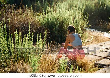 Woman relaxing among shrubs View Large Photo Image Stock Photography - Woman relaxing among shrubs. Fotosearch