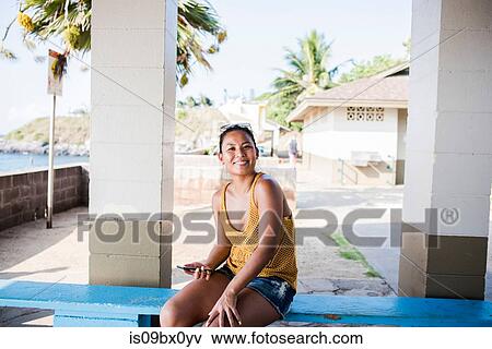 Woman sitting on bench, Hookipa Beach, Maui, Hawaii View Large Photo Image Stock Photo - Woman sitting on bench, Hookipa Beach, Maui, Hawaii. Fotosearch