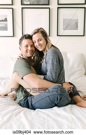 Woman sitting on mans lap looking at camera View Large Photo Image Picture - Woman sitting on mans lap looking at camera. Fotosearch