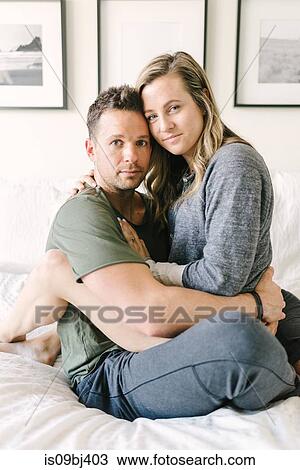 Woman sitting on mans lap looking at camera View Large Photo Image Stock Image - Woman sitting on mans lap looking at camera. Fotosearch