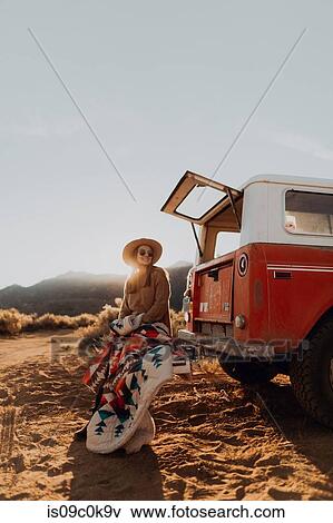 Woman sitting outside off road vehicle, Kennedy Meadows, California, US View Large Photo Image Stock Photo - Woman sitting outside off road vehicle, Kennedy Meadows, California, US. Fotosearch