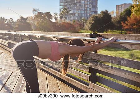 Woman stretching in city park, Barcelona, Catalonia, Spain View Large Photo Image Stock Image - Woman stretching in city park, Barcelona, Catalonia, Spain. Fotosearch