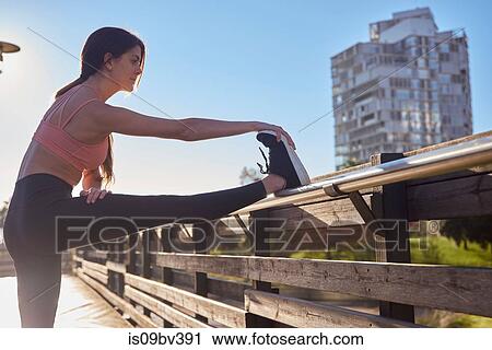 Woman stretching in city park, Barcelona, Catalonia, Spain View Large Photo Image Stock Image - Woman stretching in city park, Barcelona, Catalonia, Spain. Fotosearch