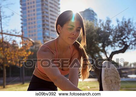 Woman stretching in city park, Barcelona, Catalonia, Spain View Large Photo Image Stock Image - Woman stretching in city park, Barcelona, Catalonia, Spain. Fotosearch