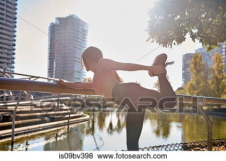 Woman stretching in city park, Barcelona, Catalonia, Spain View Large Photo Image Stock Photo - Woman stretching in city park, Barcelona, Catalonia, Spain. Fotosearch