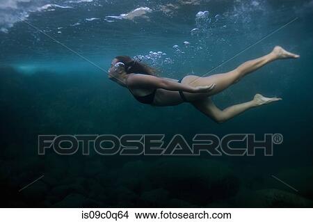 Picture - Woman swimming underwater. Fotosearch